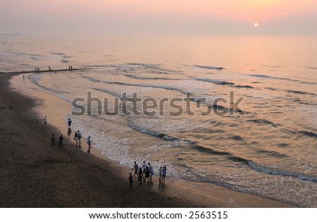 people walking on the beach. stock photo : People walking on the each in the sunset on a summer evening
