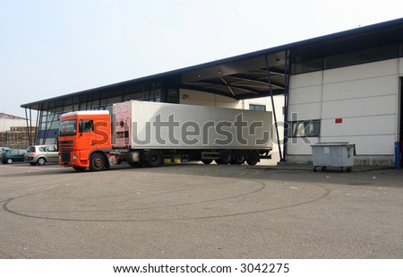 Refrigerated truck leaving the loading dock
