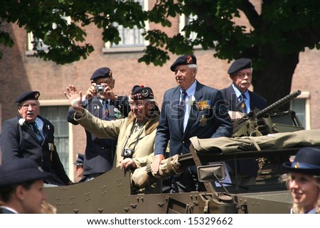 VETERANS DAY: THE HAGUE, HOLLAND - JUNE 28, 2008. Veteran soldiers on an armoured vehicle on Veterans Day Parade, June 28, 2008