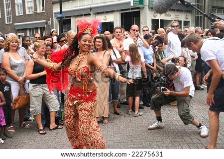 TV crew filming carnival dancer at the Caribbean Carnival in Rotterdam.