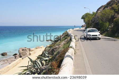 Car driving on a coastal road along the Mediterranean Sea
