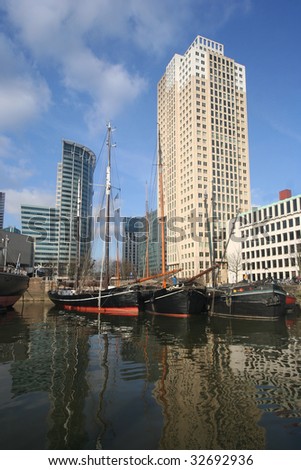 Modern office buildings and old fashioned boats