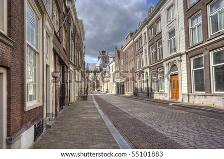 Street in historic centre of Dordrecht, Holland. Grote Kerk Church at the end of the street.