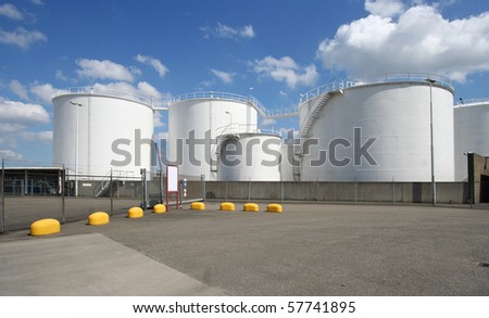 Large oil silo\'s along the road in Rotterdam harbor area