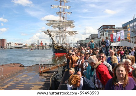 AMSTERDAM-AUGUST 19: Crowd watching the tall ships sail by at Sail 2010 on August 19, 2010 in Amsterdam, Holland