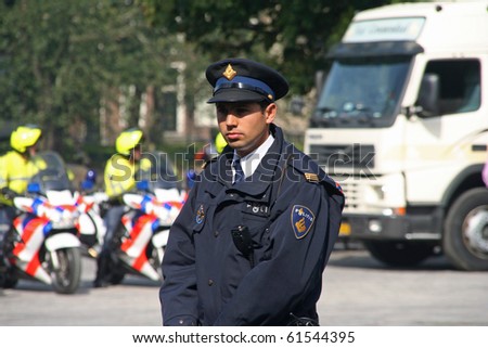 THE HAGUE, HOLLAND - SEPT 21: Young police officer on duty at the Parliament on Prinsjesdag (opening of parliamentary year by Queen) on September 21, 2010 in The Hague, Holland.