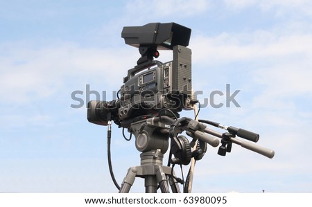 Professional film camera against a blue sky