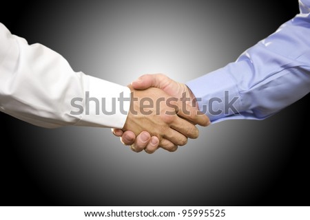Closeup of two Caucasian men shaking hands.
