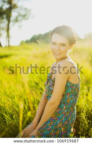 Summer girl portrait. Woman smiling happy on sunny summer or spring day outside in park