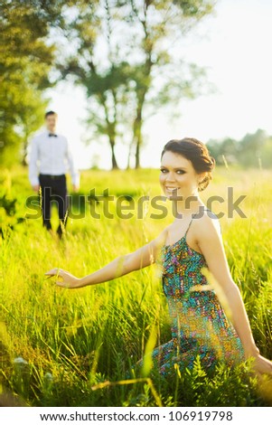 Summer girl portrait. Woman smiling happy on sunny summer or spring day outside in park with man siluet