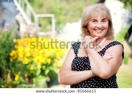 Portrait of a beautiful open smiling mature woman at the outdoor