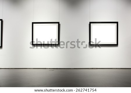 Exhibition hall with empty frames on wall