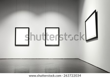 Exhibition hall with empty frames on wall