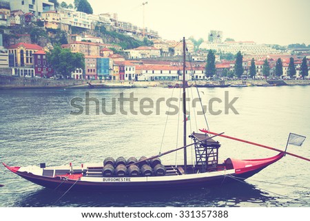 PORTO, PORTUGAL - May 13, 2012: Boat with barrels of port wine on Douro river in Porto. Instagram style filtered image