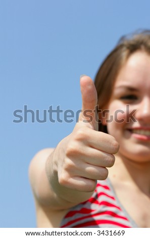 Teen girl show thumbs up