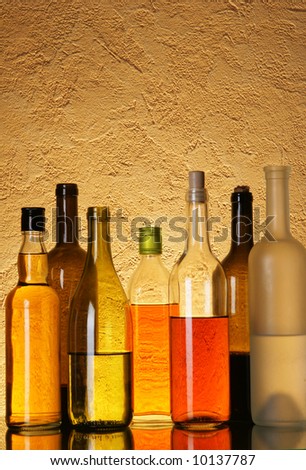 Lots bottles of alcoholic beverages over textured background