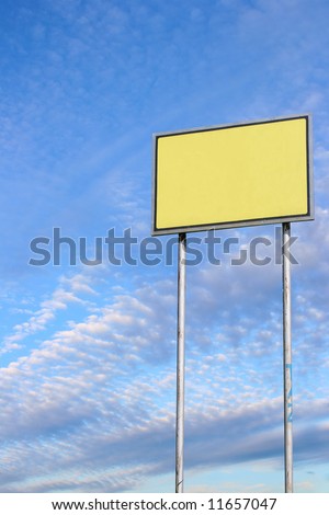 Small blank sign against deep blue sky background