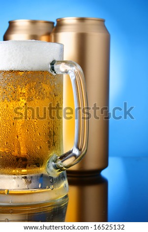 Beer mug and cans over blue background