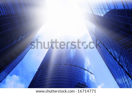 Modern skyscrapers close-up and sun glare