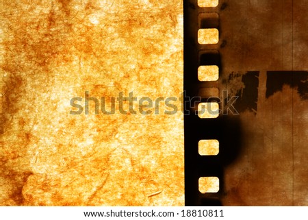 Old film strip over grunge paper background