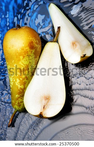 Pears close-up over blue backgrounds with water