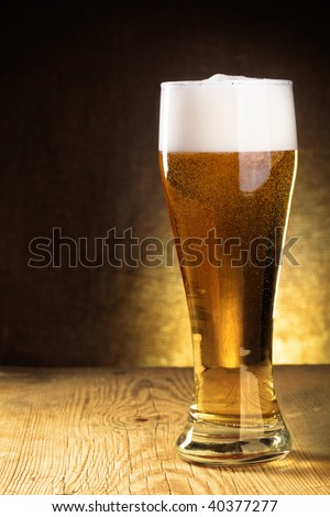 Single  beer glass close-up on wooden table