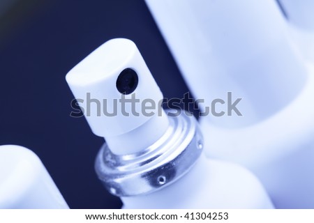 Three spray cans with medication close up