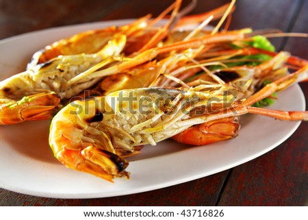 Grilled big shrimps on plate close up