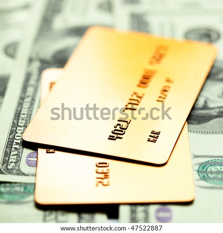 Gold credit cards on dollar notes. Shalow DOF!