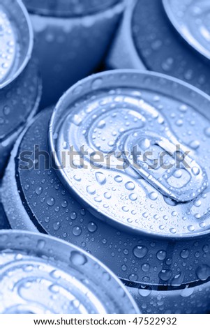 Blue drinking cans with water drops. Shallow DOF!