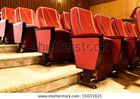 Empty red theater seats close up