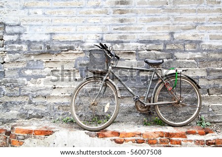 Lonely vintage bicycle near old brick wall