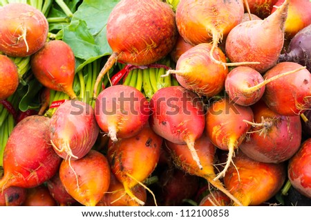 Fresh orange or red beets on display at the market