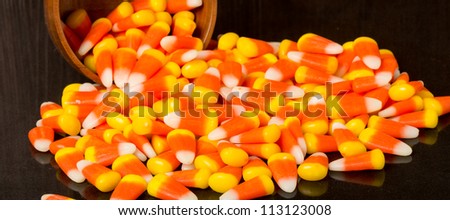 Candy corn sweets spilling onto table