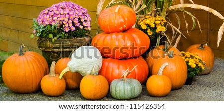 Fall display of decorations with pumpkins and flowers