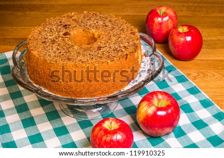 Red apples on table with homemade apple cake