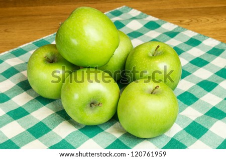 Granny Smith apples on checked cloth