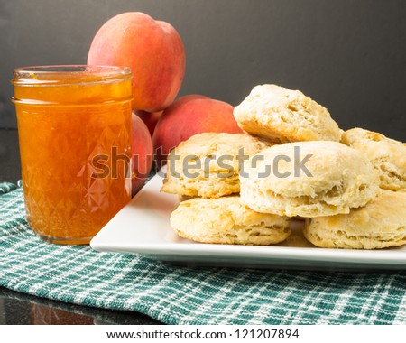 Plate of biscuits with peaches and peach jam
