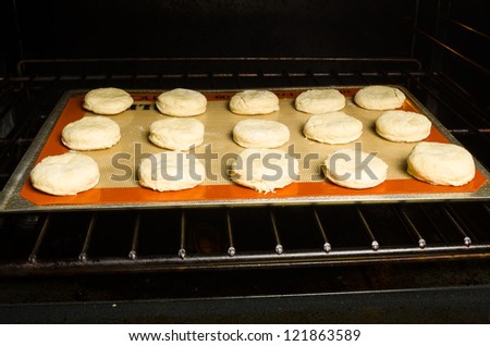 A tray of biscuits in the oven to bake