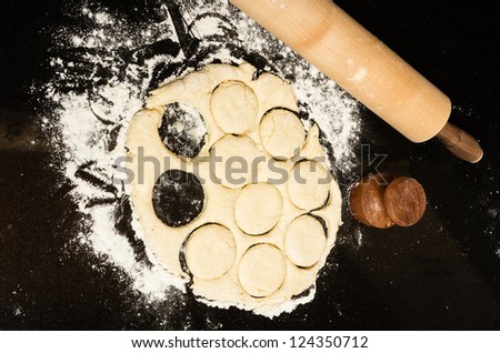 Dough with biscuit cutter and rolling pin and flour