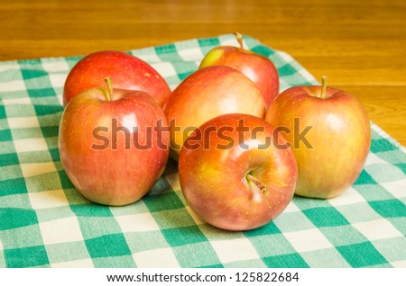Fresh Fuji apples on a green checked cloth