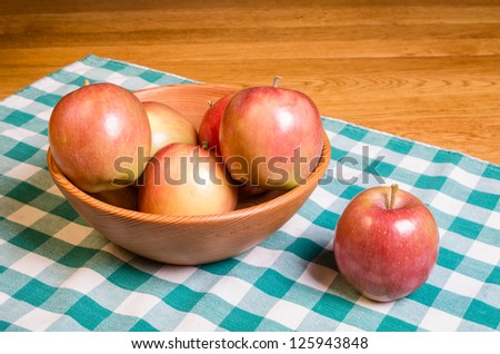 Group of Fuji apples in a wooden bowl