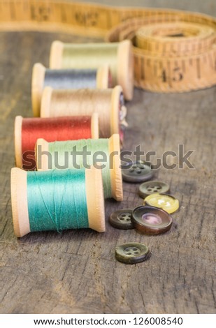 Buttons and measuring tape with spools of thread