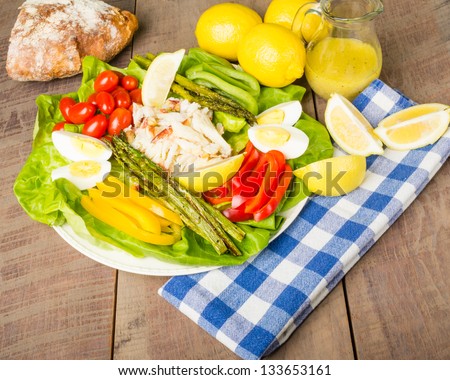 Fresh crab salad with asparagus and lemons and loaf of bread