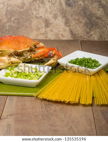 Ingredients for making Dungeness crab pasta on a cutting board