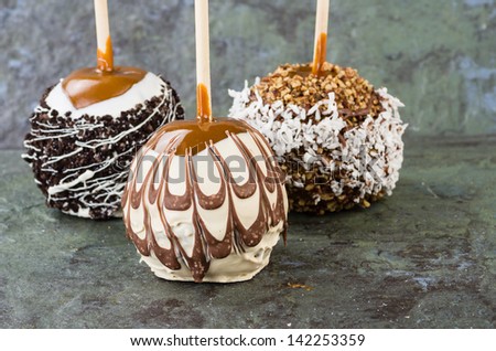 Sweet chocolate or caramel covered apples with nuts