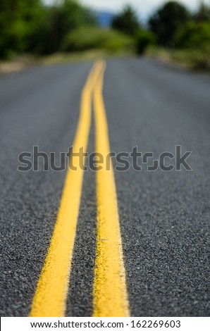 Yellow traffic control lines on a rural roadway