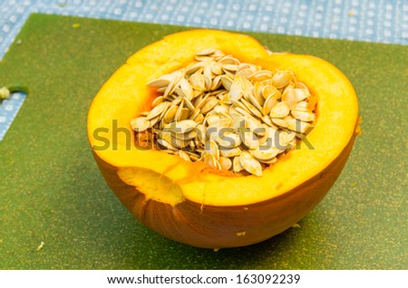 Pumpkins cut open to extract the seeds