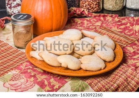 Pumpkin cookies or biscuits on plate with pumpkin