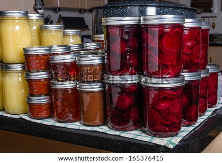 Preserved foods in mason jars on a counter